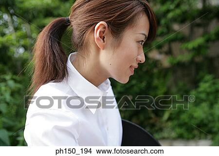 Picture - Side profile of a waitress smiling. Fotosearch