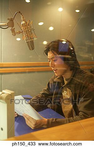Side profile of a young man recording music in a recording studio View Large Photo Image Stock Image - Side profile of a young man recording music in a recording studio. Fotosearch
