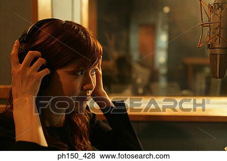 Side profile of a young woman in a recording studio View Large Photo Image Stock Photo - Side profile of a young woman in a recording studio. Fotosearch