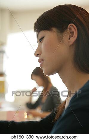 Side profile of a young woman looking serious View Large Photo Image Stock Image - Side profile of a young woman looking serious. Fotosearch