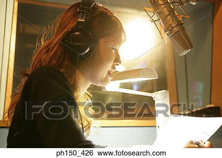 Side profile of a young woman recording music in recording studio View Large Photo Image Stock Photograph - Side profile of a young woman recording music in recording studio. Fotosearch