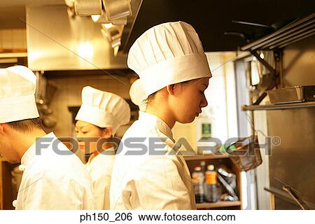 Side profile of two female chefs and a male chef working in the kitchen View Large Photo Image Stock Photograph - Side profile of two female chefs and a male chef working in the kitchen. Fotosearch