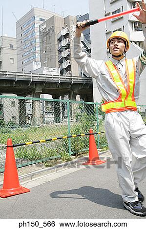 Traffic cop directing traffic with a nightstick View Large Photo Image Stock Photograph - Traffic cop directing traffic with a nightstick. Fotosearch