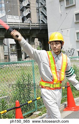 Traffic cop directing traffic with a nightstick View Large Photo Image Stock Photography - Traffic cop directing traffic with a nightstick. Fotosearch
