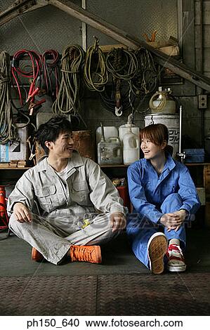 Two auto mechanics talking in an auto repair shop View Large Photo Image Stock Image - Two auto mechanics talking in an auto repair shop. Fotosearch