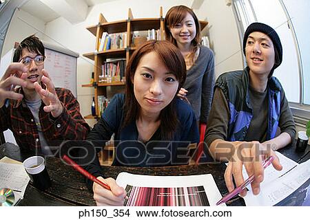 Two businesswomen and two businessmen discussing in an office View Large Photo Image Picture - Two businesswomen and two businessmen discussing in an office. Fotosearch