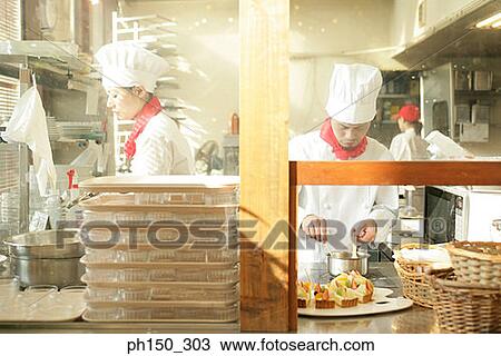 Two female chefs and a male chef in the kitchen View Large Photo Image Stock Image - Two female chefs and a male chef in the kitchen. Fotosearch