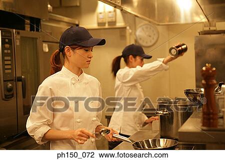 Two female chefs preparing food in the kitchen View Large Photo Image Stock Image - Two female chefs preparing food in the kitchen. Fotosearch