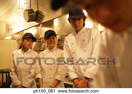 Two male chefs and two female chefs in the kitchen View Large Photo Image Stock Image - Two male chefs and two female chefs in the kitchen. Fotosearch