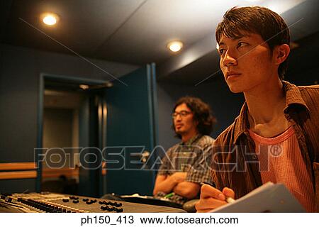 Two young men in a recording studio View Large Photo Image Stock Image - Two young men in a recording studio. Fotosearch