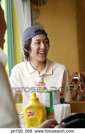 Waiter and his colleague sitting in a restaurant and smiling View Large Photo Image Stock Photo - Waiter and his colleague sitting in a restaurant and smiling. Fotosearch