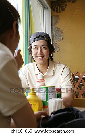 Waiter and his colleague sitting in a restaurant and smiling View Large Photo Image Stock Photo - Waiter and his colleague sitting in a restaurant and smiling. Fotosearch