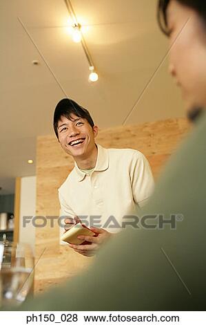 Waiter writing on a notepad and smiling View Large Photo Image Stock Photo - Waiter writing on a notepad and smiling. Fotosearch