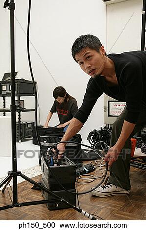 Young man and a young woman in a film studio View Large Photo Image Stock Image - Young man and a young woman in a film studio. Fotosearch