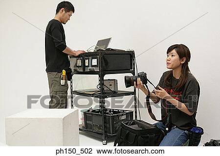 Young man and a young woman in a film studio View Large Photo Image Stock Image - Young man and a young woman in a film studio. Fotosearch