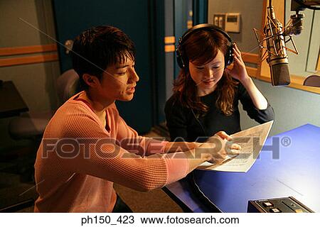 Young woman and a young man recording in a recording studio View Large Photo Image Stock Image - Young woman and a young man recording in a recording studio. Fotosearch