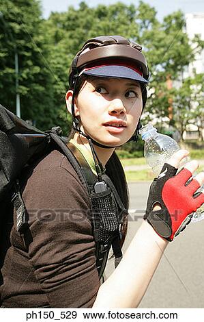 Stock Photo - Young woman holding a water bottle. Fotosearch
