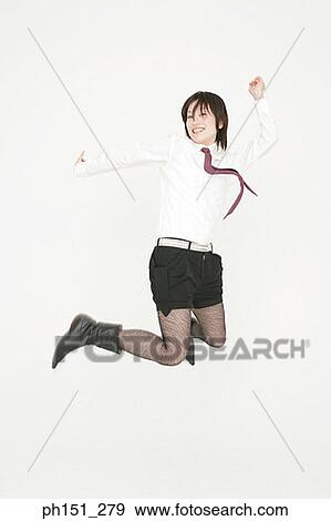 Stock Photo - Businesswoman jumping in mid-air. Fotosearch