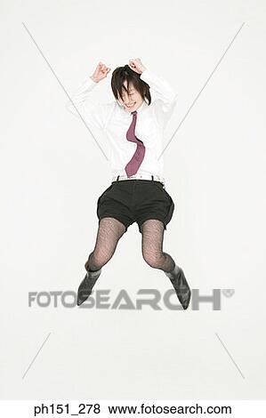 Businesswoman jumping with her eyes closed View Large Photo Image Stock Photo - Businesswoman jumping with her eyes closed. Fotosearch