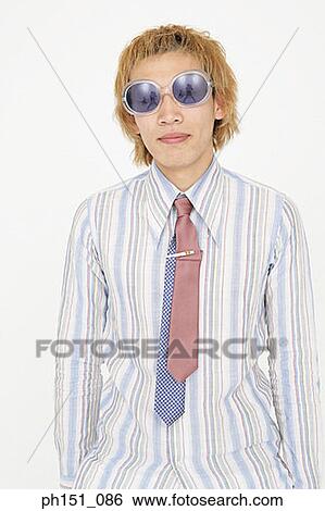 Close-up of a teenage boy wearing sunglasses and smiling View Large Photo Image Stock Photograph - Close-up of a teenage boy wearing sunglasses and smiling. Fotosearch