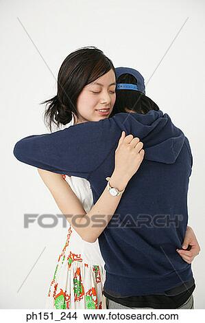 Picture - Close-up of a young couple embracing each other. Fotosearch