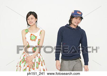 Stock Image - Close-up of a young couple smiling. Fotosearch