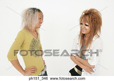 Close-up of a young couple talking and smiling View Large Photo Image Stock Photograph - Close-up of a young couple talking and smiling. Fotosearch