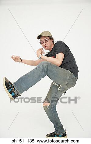 Close-up of a young man kicking View Large Photo Image Stock Photography - Close-up of a young man kicking. Fotosearch