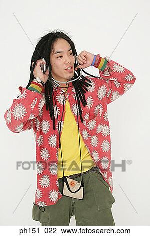 Stock Image - Close-up of a young man wearing headphones and listening to music. Fotosearch