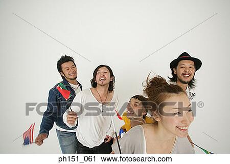 Close-up of a young woman holding a Japanese flag with four young men looking cheerful View Large Photo Image Stock Image - Close-up of a young woman holding a Japanese flag with four young men looking cheerful. Fotosearch