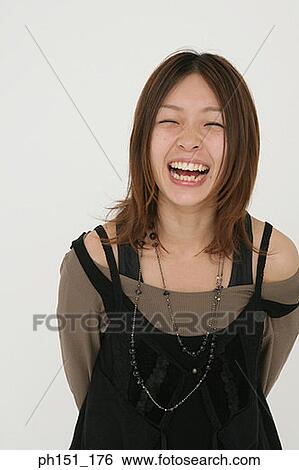 Stock Photograph - Close-up of a young woman laughing. Fotosearch