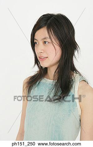 Close-up of a young woman looking away View Large Photo Image Stock Image - Close-up of a young woman looking away. Fotosearch