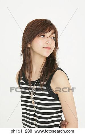 Close-up of a young woman looking sideways View Large Photo Image Stock Photo - Close-up of a young woman looking sideways. Fotosearch