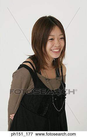 Close-up of a young woman smiling View Large Photo Image Stock Photo - Close-up of a young woman smiling. Fotosearch