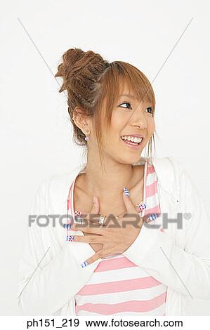 Close-up of a young woman smiling View Large Photo Image Stock Photo - Close-up of a young woman smiling. Fotosearch