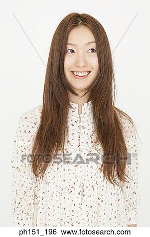 Close-up of a young woman smiling View Large Photo Image Stock Photograph - Close-up of a young woman smiling. Fotosearch