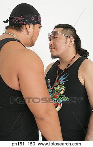 Close-up of two mid adult men looking at each other View Large Photo Image Stock Image - Close-up of two mid adult men looking at each other. Fotosearch