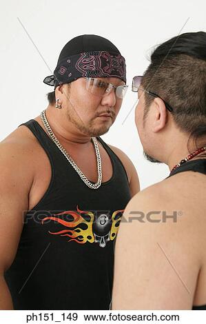 Close-up of two mid adult men looking at each other View Large Photo Image Stock Photo - Close-up of two mid adult men looking at each other. Fotosearch