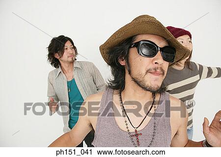 Close-up of two young men and a young woman dancing View Large Photo Image Stock Image - Close-up of two young men and a young woman dancing. Fotosearch