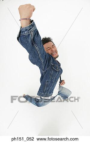 High angle view of a young man jumping with his eyes closed View Large Photo Image Stock Image - High angle view of a young man jumping with his eyes closed. Fotosearch