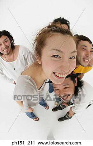 High angle view of a young woman smiling with four young men View Large Photo Image Stock Image - High angle view of a young woman smiling with four young men. Fotosearch