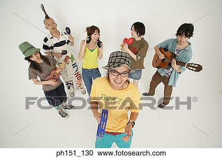 High angle view of three young couples playing musical instruments and smiling View Large Photo Image Stock Image - High angle view of three young couples playing musical instruments and smiling. Fotosearch