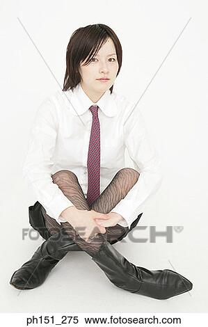 Stock Photography - Portrait of a businesswoman sitting with her legs crossed. Fotosearch