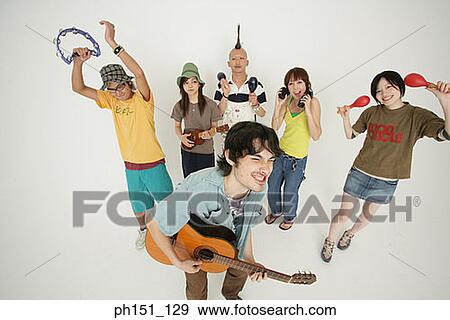Portrait of a group of young people playing musical instruments View Large Photo Image Stock Photo - Portrait of a group of young people playing musical instruments. Fotosearch