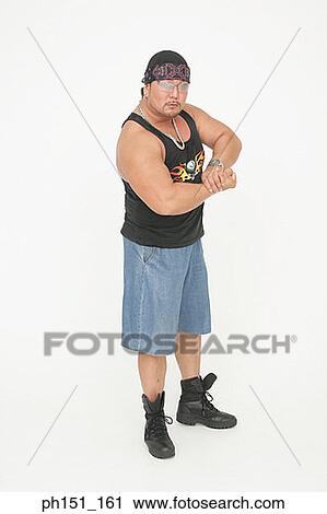 Stock Image - Portrait of a mid adult man flexing his muscles. Fotosearch