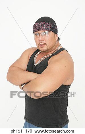 Stock Image - Portrait of a mid adult man standing with his arms crossed. Fotosearch