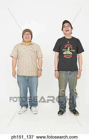 Portrait of a young man and a mid adult man smiling View Large Photo Image Stock Photo - Portrait of a young man and a mid adult man smiling. Fotosearch