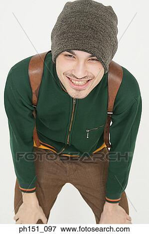 Portrait of a young man bending down and smiling View Large Photo Image Stock Photo - Portrait of a young man bending down and smiling. Fotosearch