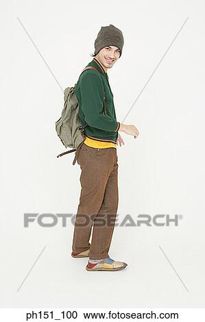 Portrait of a young man carrying a backpack and smiling View Large Photo Image Stock Image - Portrait of a young man carrying a backpack and smiling. Fotosearch