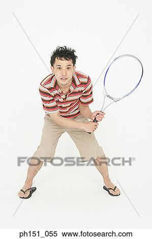 Portrait of a young man holding a badminton racket and smiling View Large Photo Image Stock Photography - Portrait of a young man holding a badminton racket and smiling. Fotosearch